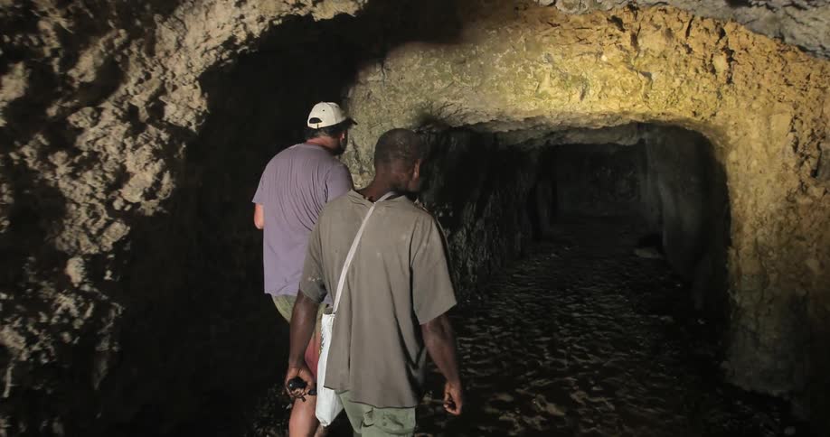Men enter a deep cave