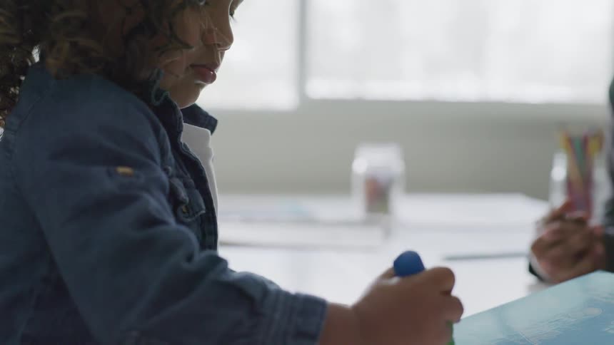 A child drawing in paper