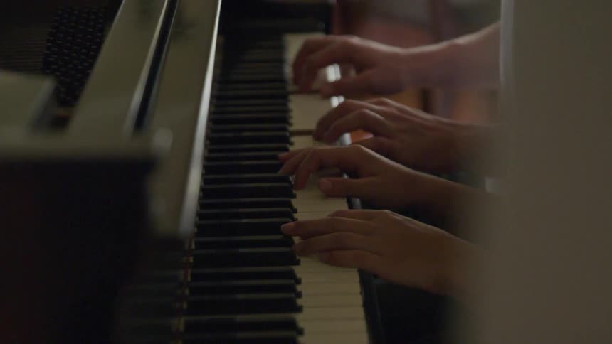 2 people playing pianos