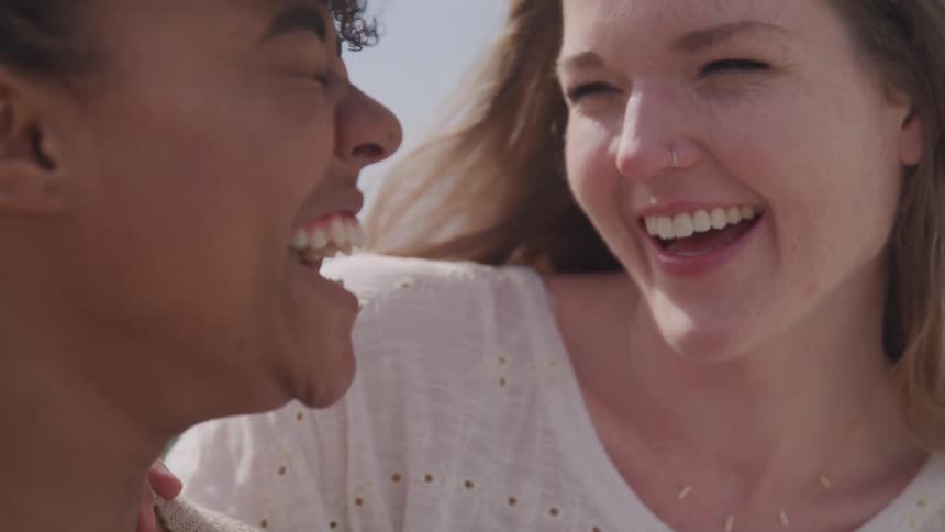 Three women laugh together