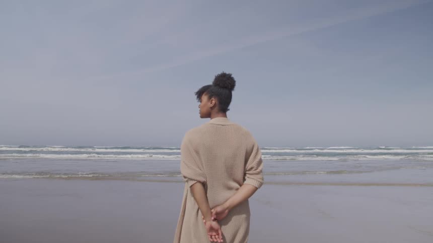 A woman watches the waves