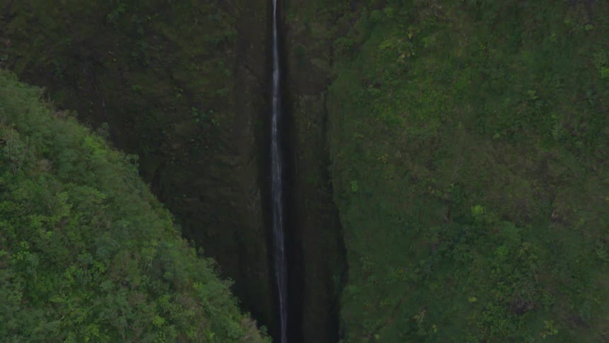 The stream runs past the green hills