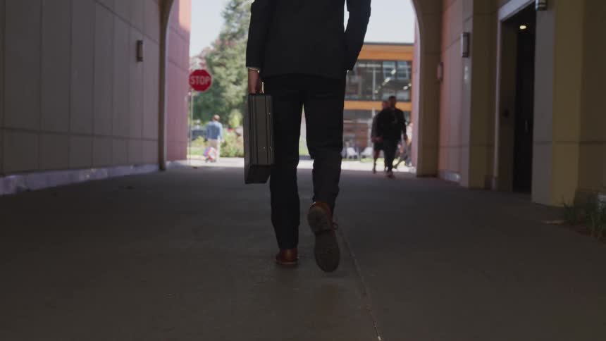 A man walks through the archway