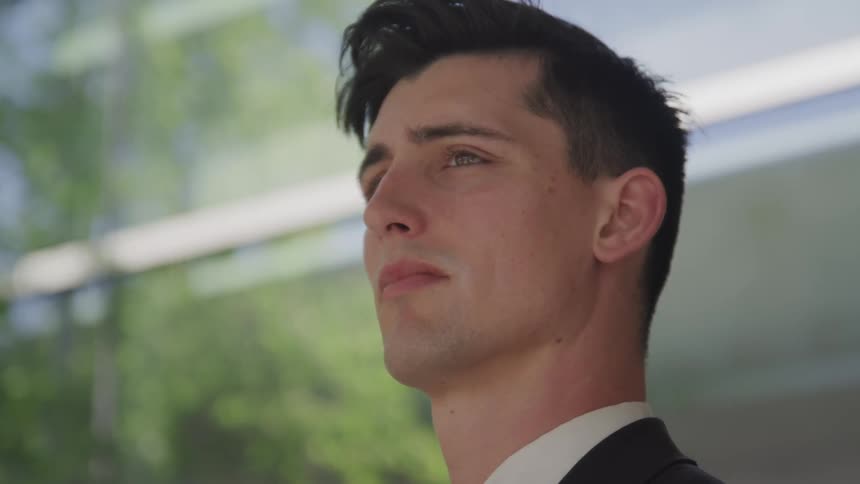 A man with suit contemplatively thinking