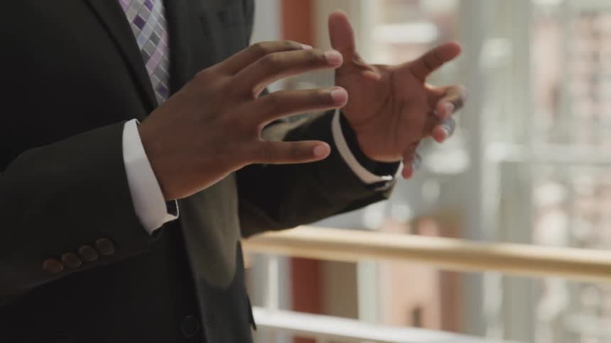 Hand gesture of black man with suit