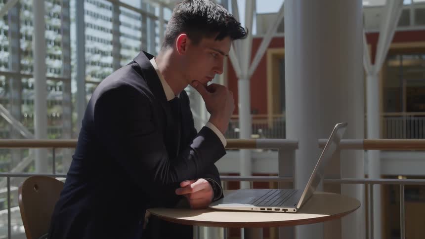 A man with suit working at the cafe
