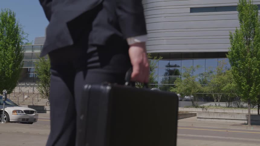 A man stands with his briefcase