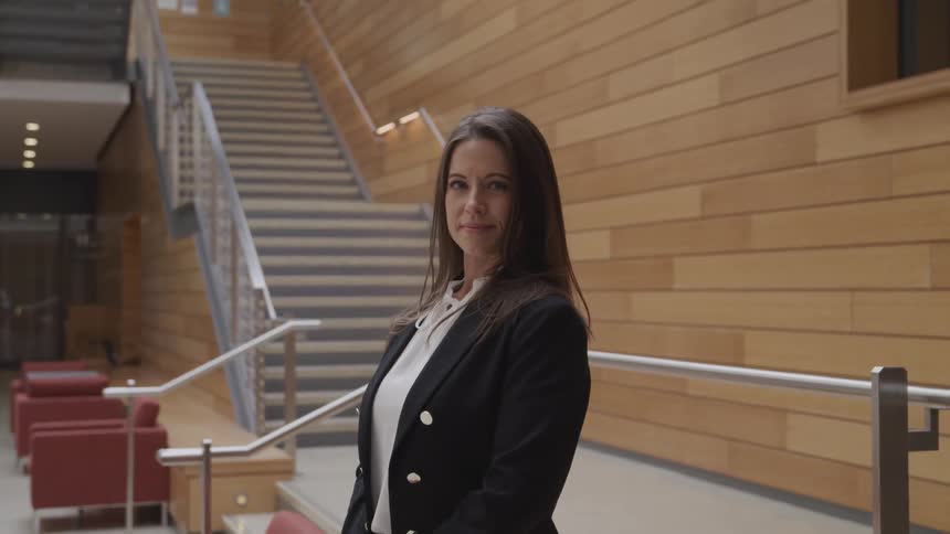 Businesswoman turns and smiles at the camera in the office