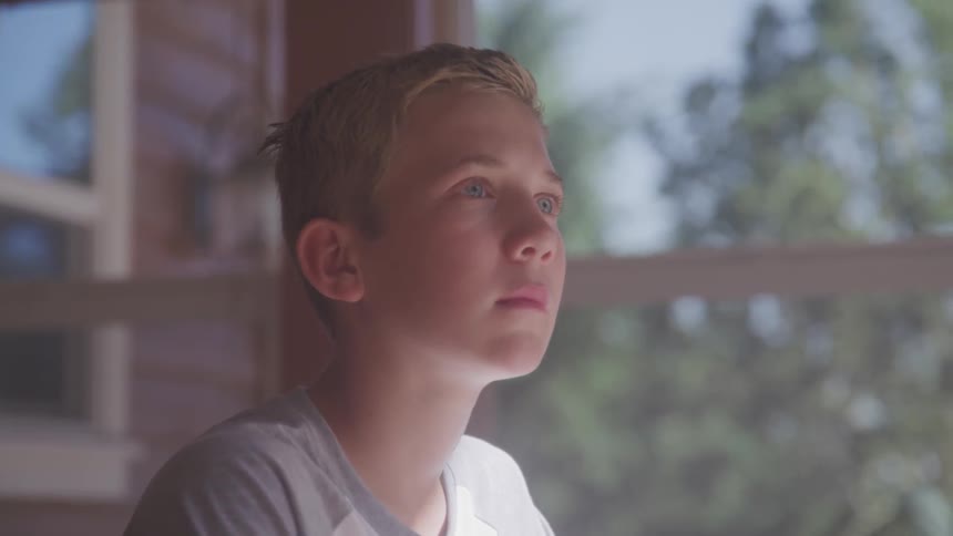 A boy is sitting in a room