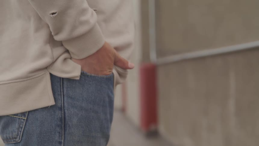 A man puts his hand in his pocket