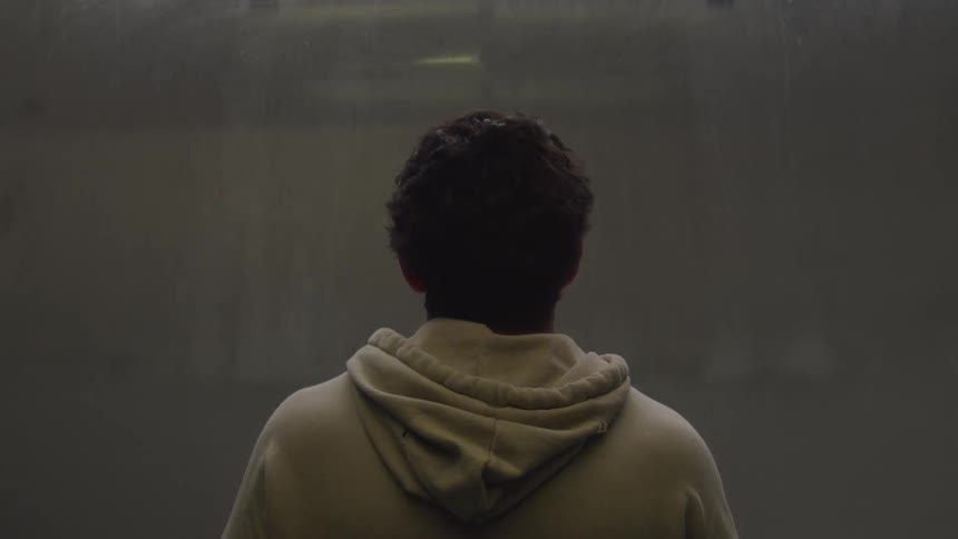 A man rides an elevator down to the ground floor