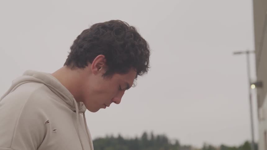 A man with white hoodie staring at the sky