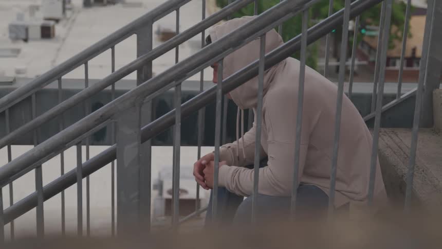 A man is sitting on the steps