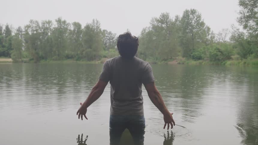 Man posing in the middle of a river