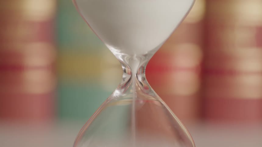 Sand pours through an hourglass