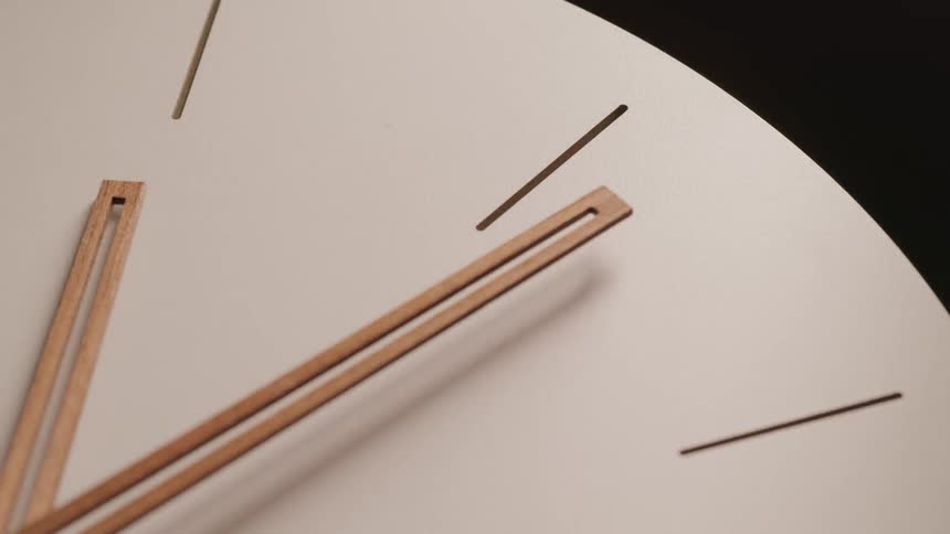 A clock face is briefly illuminated