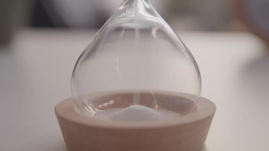 The sand glass pours as time passes