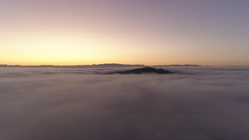 A scenery of mountain peak above the cloud at sunset