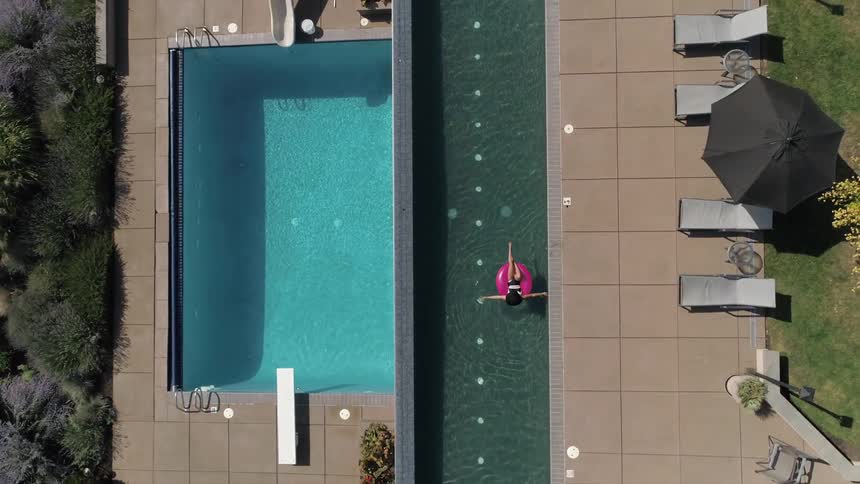 Woman floats on an inner tube in apool