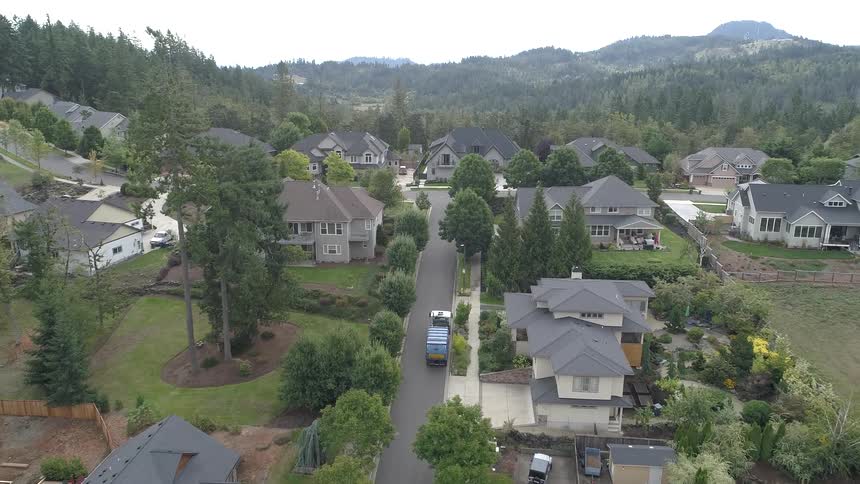 A truck is driving through a suburban neighborhood