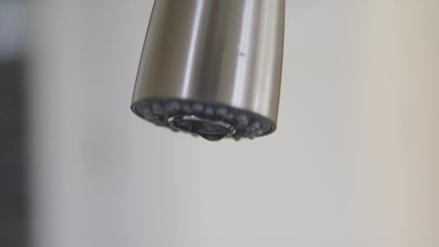 Water dripping out of a faucet