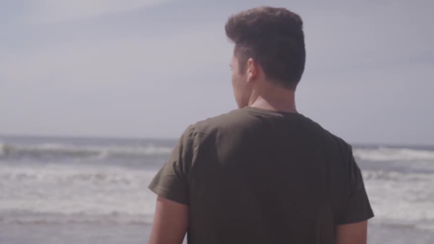 A man walks towards the ocean
