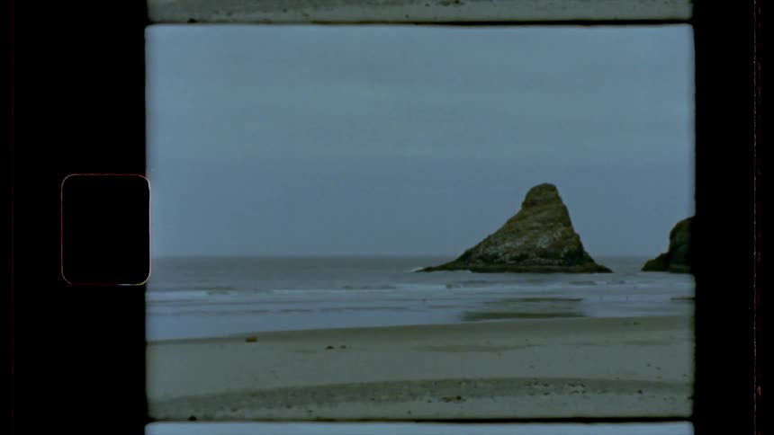 Film footage of a beach and cliff