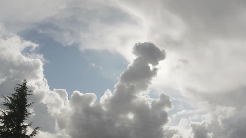 Dark clouds float in the sky on a sunny day