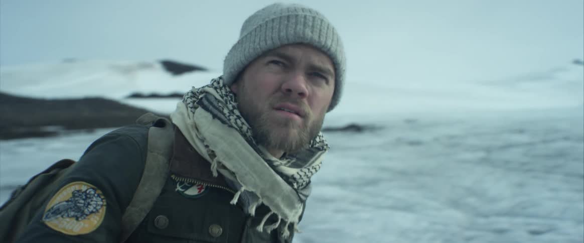 A man looking around in a snow ountain