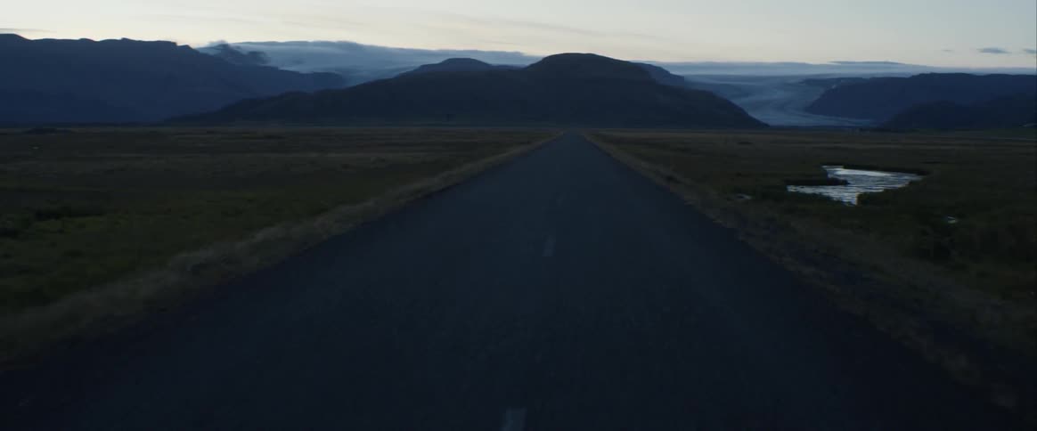 A road is going through a grassland area