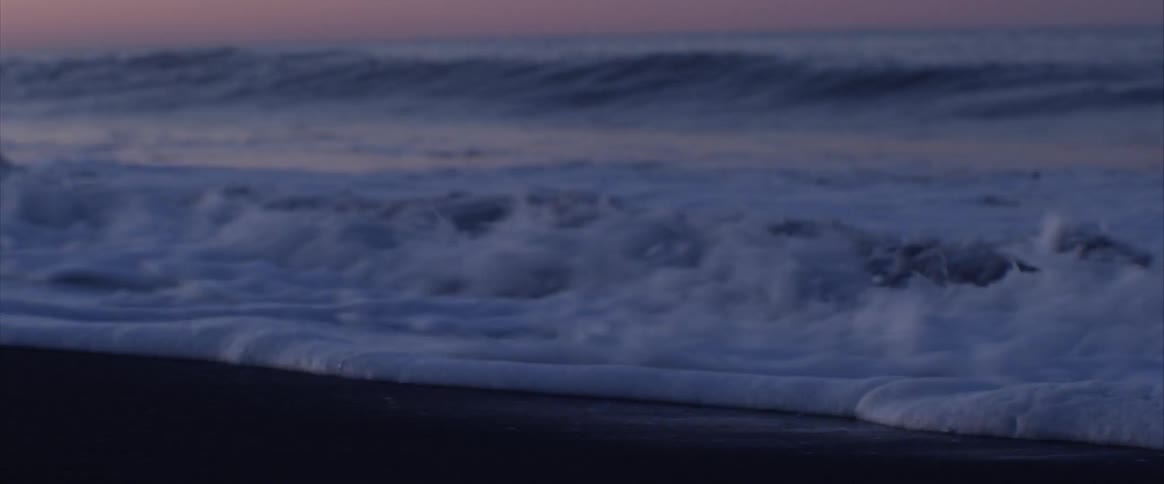 Foamy waves washing into a beach