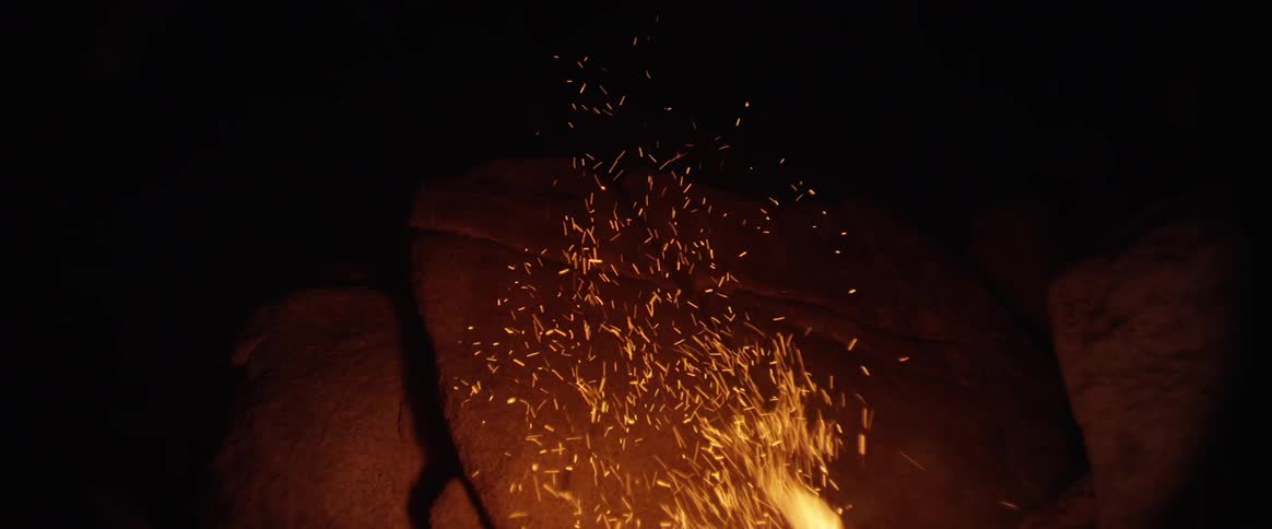 Embers floating above a fire in a cave