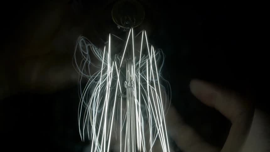A glowing orb manipulated by a human hand