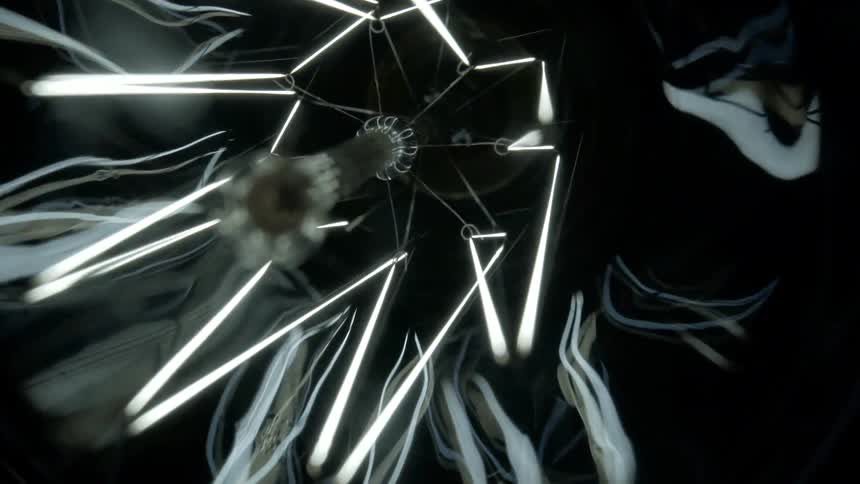 An abstract light hanging from a ceiling