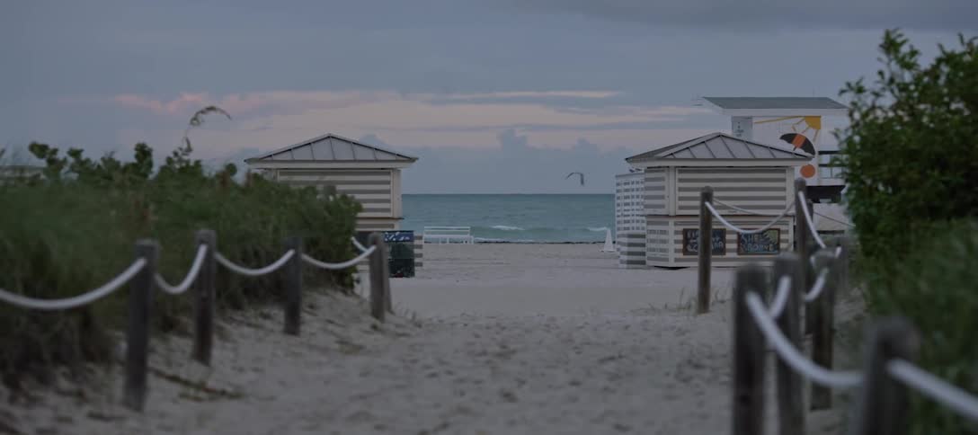 A path to the beach is marked by posts and rope