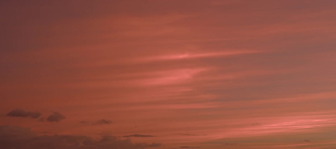 Clouds in a pink glowing sky at sunset