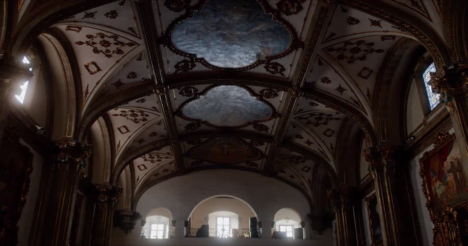 Ornate art and windows decorate the inside of a church