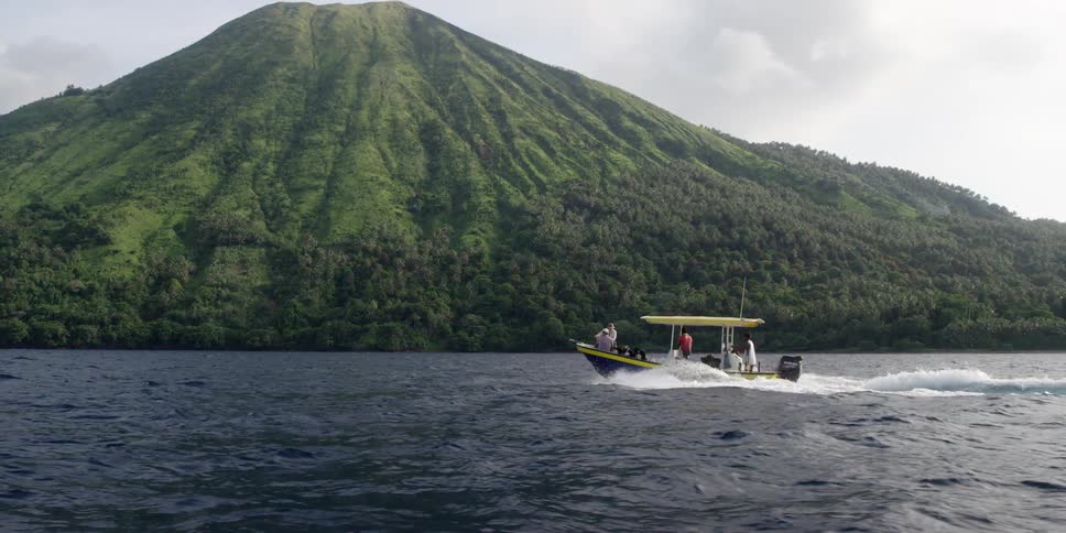 Boaters traveling underneath volcano