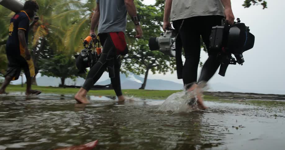Divers with equipment headed towards boat