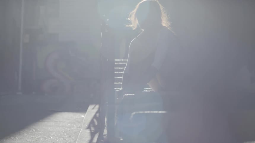 A woman with auburn hair prepares for a dancing session