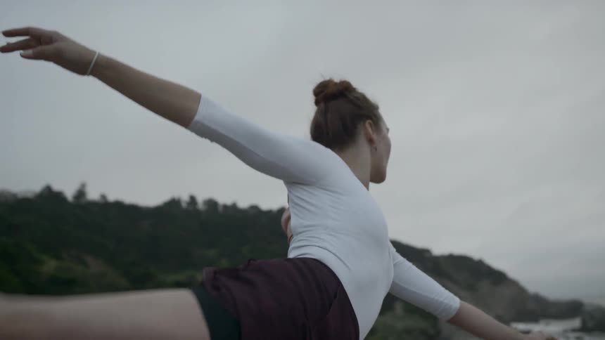 A woman dancing by the beach