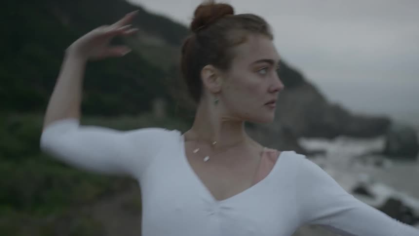 A ballet dancer dances on the beach