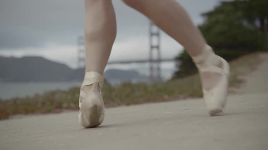 A ballerina dances outside