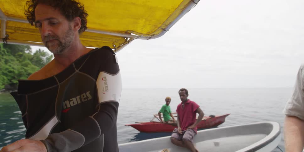A man putting on a wet suit