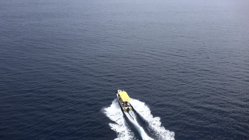 A boat heads out to sea