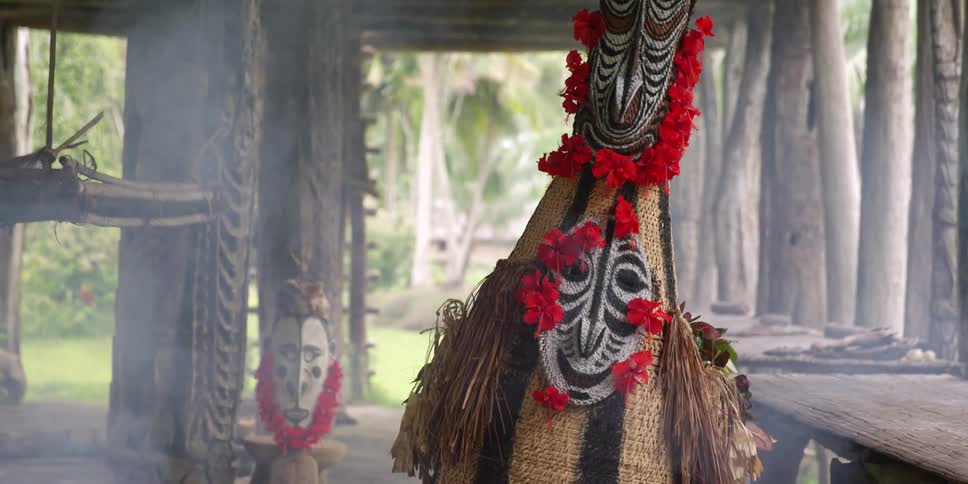 A person in costume dancing in a smoky area