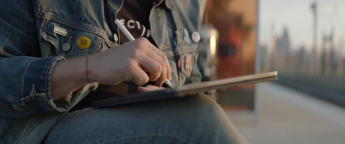 A man drawing on a tablet with a pen