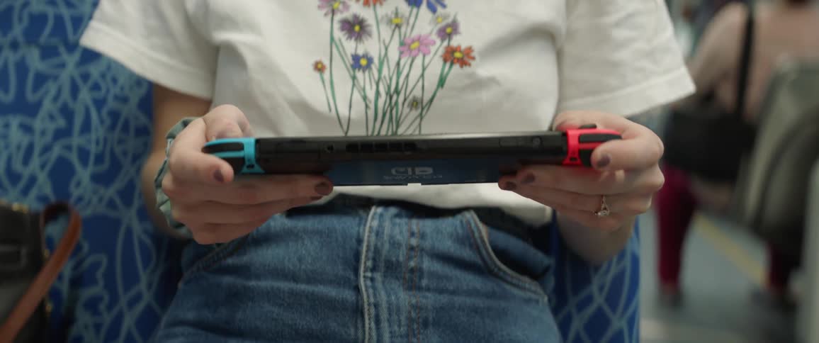 A woman sits and plays a game