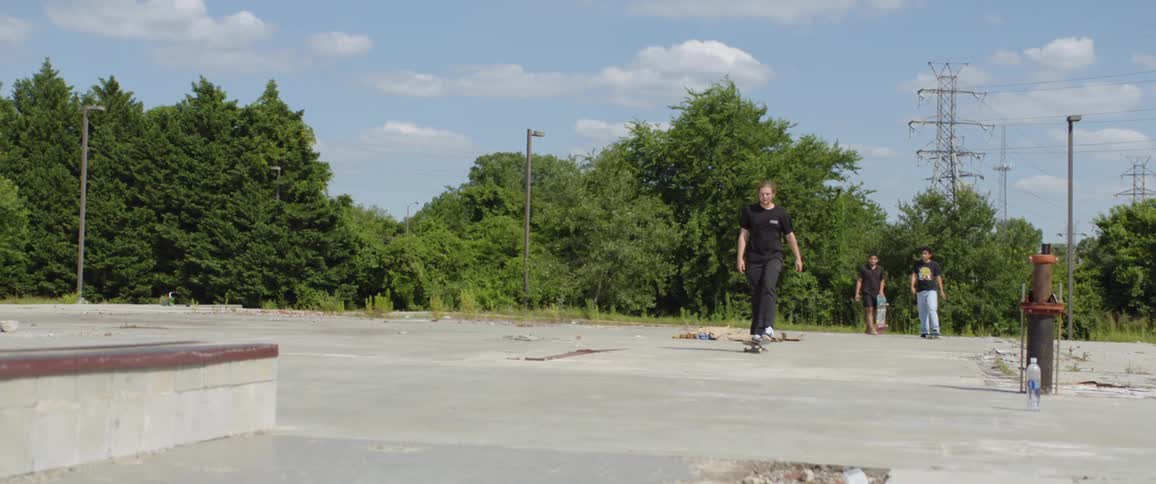 A group of man playing skateboard at the park