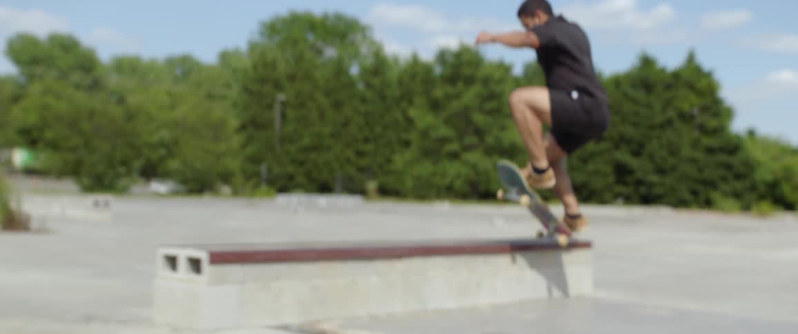 A young male takes pictures of a teenager skateboarding
